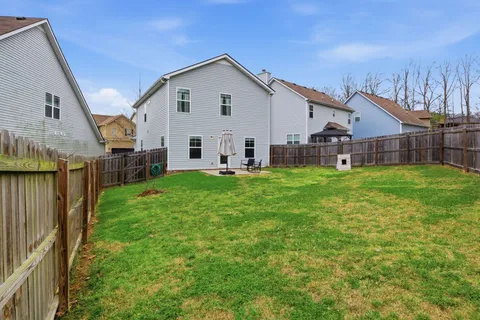 a view of a house with a yard and porch
