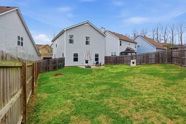 a view of a house with a yard and porch