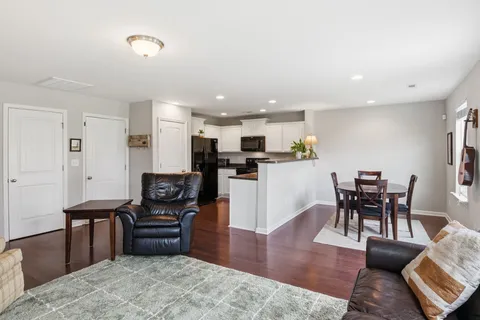 a living room with furniture and kitchen view