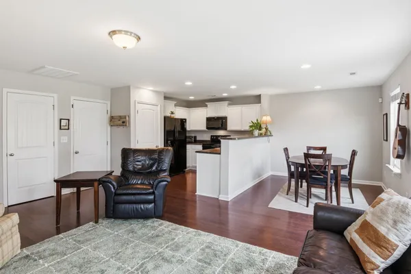 a living room with furniture and kitchen view