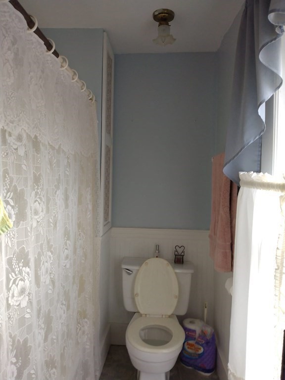 7 Maple Place Winchendon, MA 01475 - Photo 16 of 28 a white toilet sitting next to a bathroom sink and vanity