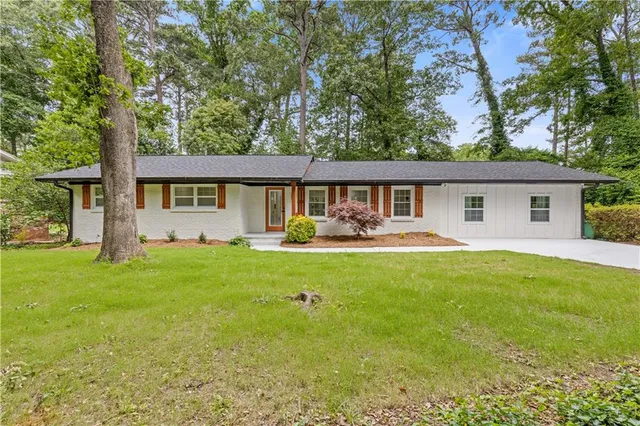 a front view of house with yard and green space