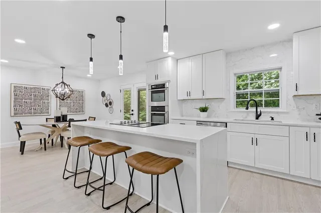 a kitchen with cabinets and chairs