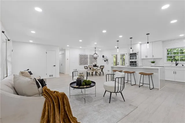 a living room with furniture and kitchen view