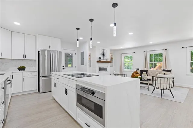a kitchen with white cabinets and stainless steel appliances