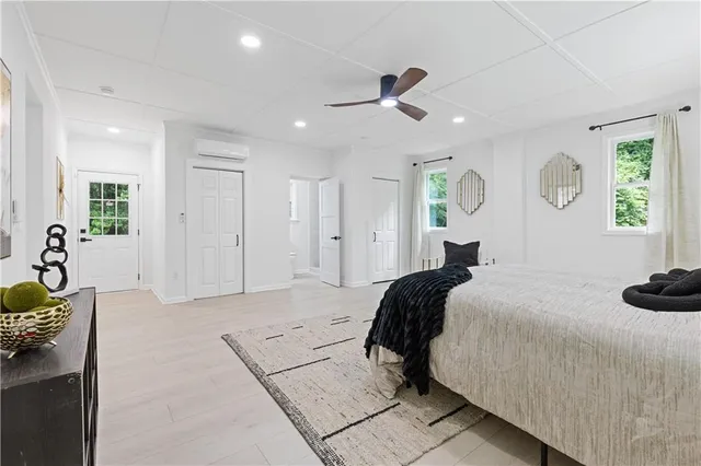 a bedroom with a bed and ceiling fan