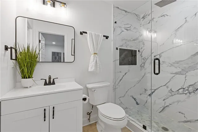 a bathroom with a toilet sink and shower