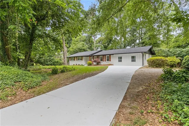 a view of house with yard and green space
