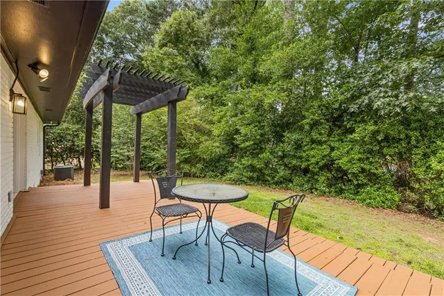 a patio with glass top table and chairs