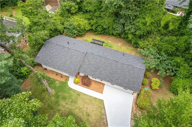 an aerial view of a house with a yard and swimming pool