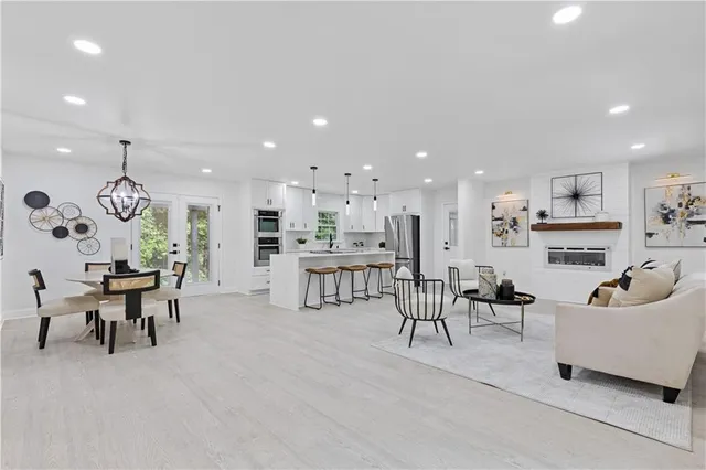a living room with furniture and kitchen view