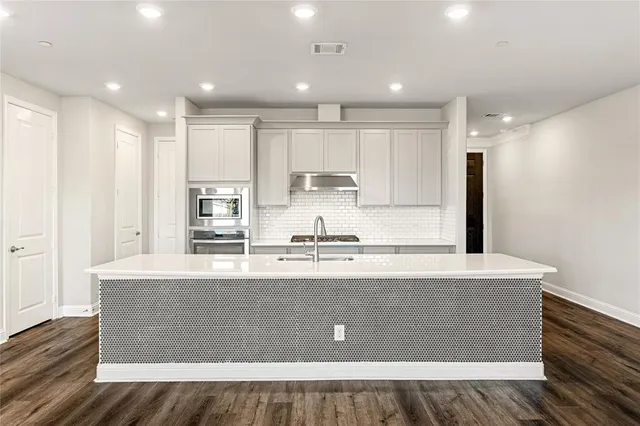 a view of a kitchen with a dishwasher and cabinets
