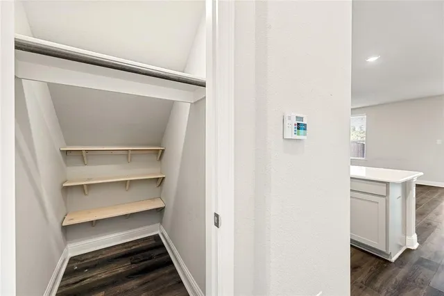 a view of kitchen with kitchen island sink refrigerator and window