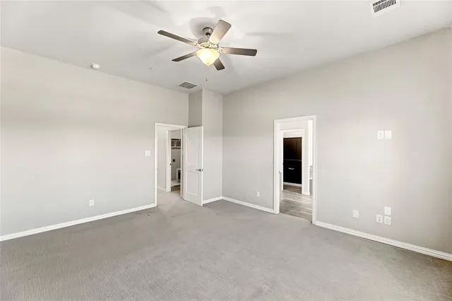 a view of a livingroom with a ceiling fan and entryway