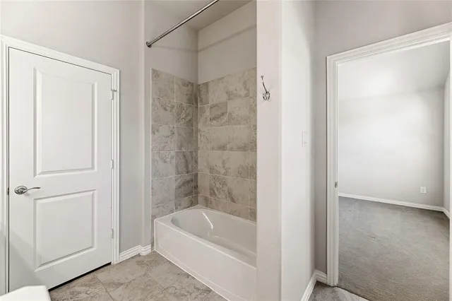 a bathroom with a tub and shower