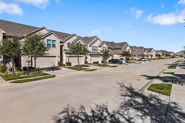a bathroom with a double vanity sink a mirror and a bathtub