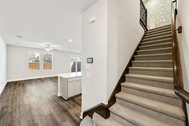a view of an entryway with wooden floor and staircase