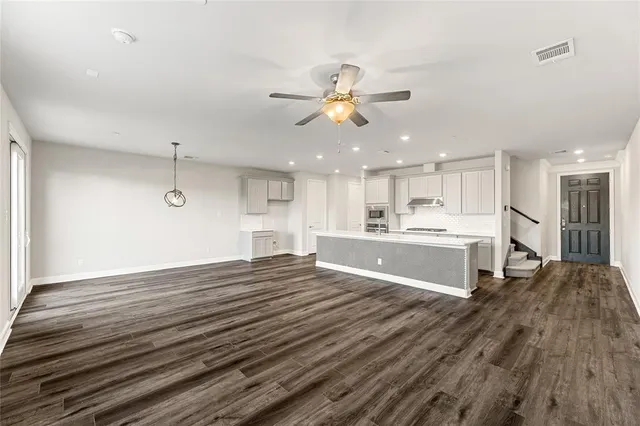 a view of kitchen with sink and refrigerator