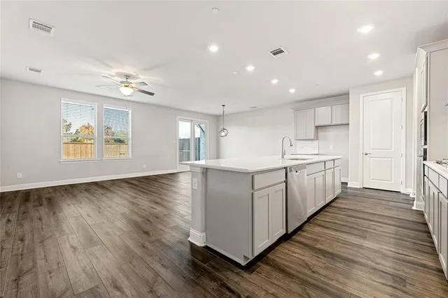a view of a backyard with plants and a lake view
