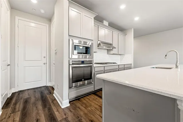 a kitchen with a sink window and cabinets