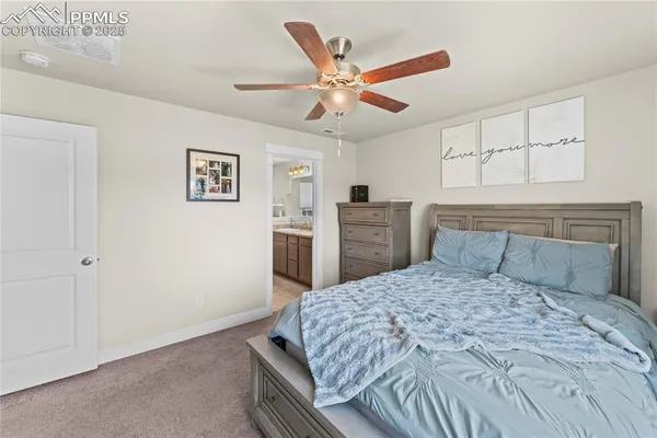 a bedroom with a large bed and a chandelier