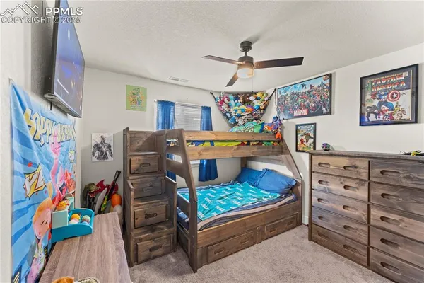 a bedroom with furniture and a baby crib