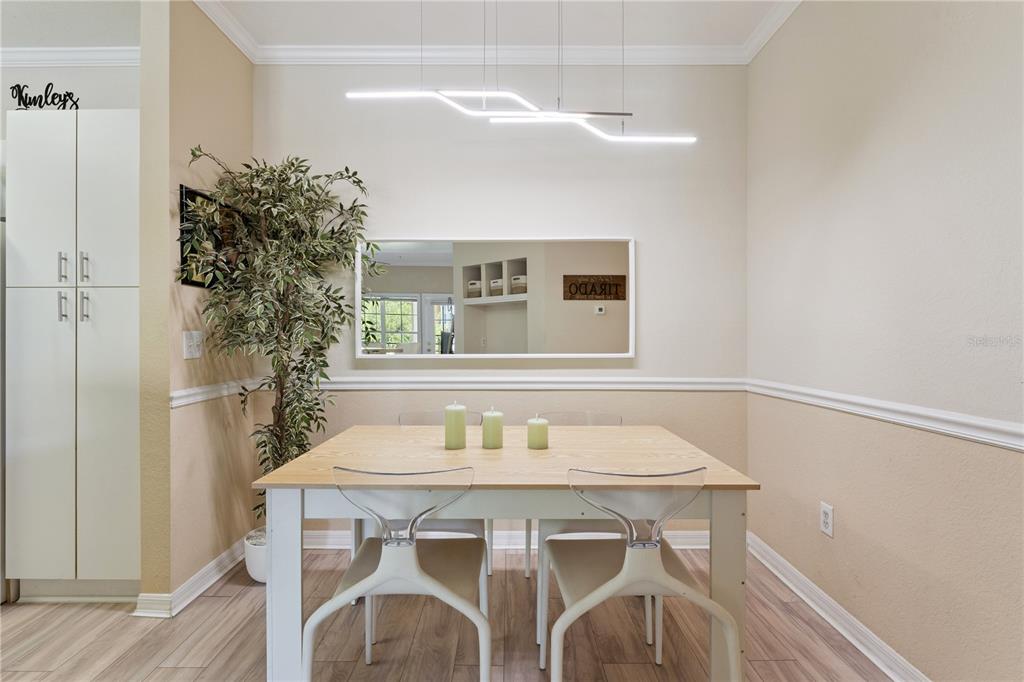 3751 Conroy Road, Unit 2325 Orlando, FL 32839 - Photo 12 of 31 a view of a dining room with furniture and wooden floor