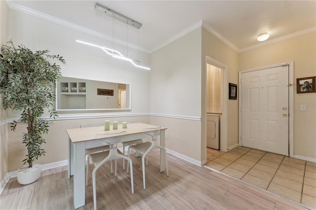 3751 Conroy Road, Unit 2325 Orlando, FL 32839 - Photo 13 of 31 a kitchen with furniture and a refrigerator