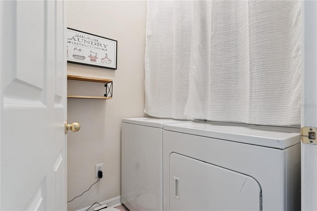3751 Conroy Road, Unit 2325 Orlando, FL 32839 - Photo 14 of 31 a view of a hallway with washer and dryer