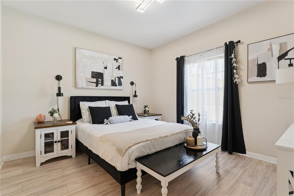 3751 Conroy Road, Unit 2325 Orlando, FL 32839 - Photo 15 of 31 a bedroom with a bed and a night stand