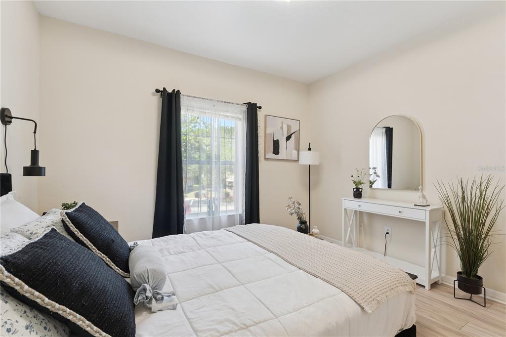 3751 Conroy Road, Unit 2325 Orlando, FL 32839 - Photo 16 of 31 a bedroom with a large bed and a potted plant
