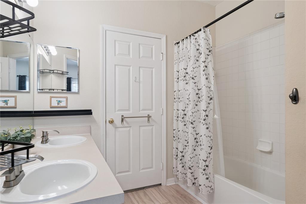 3751 Conroy Road, Unit 2325 Orlando, FL 32839 - Photo 18 of 31 a bathroom with a sink and a mirror
