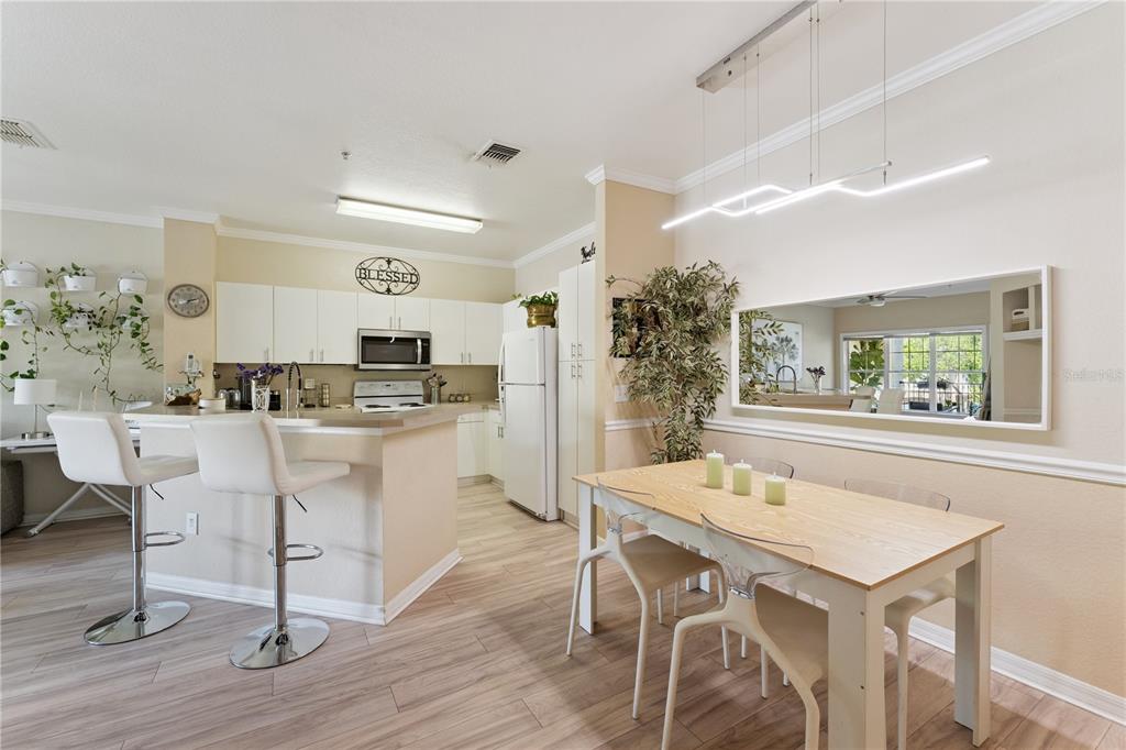 3751 Conroy Road, Unit 2325 Orlando, FL 32839 - Photo 5 of 31 a kitchen with a table and chairs in it