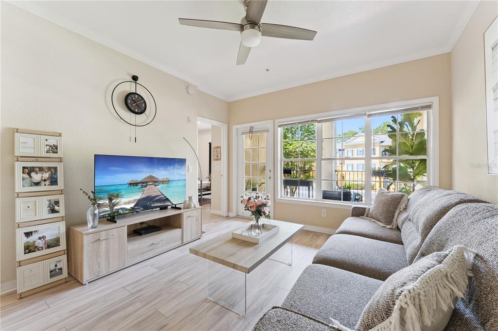 3751 Conroy Road, Unit 2325 Orlando, FL 32839 - Photo 6 of 31 a living room with furniture and a flat screen tv