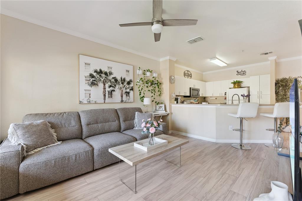 3751 Conroy Road, Unit 2325 Orlando, FL 32839 - Photo 7 of 31 a living room with furniture and kitchen view