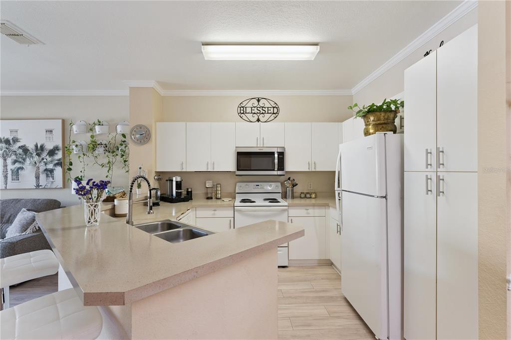 3751 Conroy Road, Unit 2325 Orlando, FL 32839 - Photo 9 of 31 a kitchen with stainless steel appliances granite countertop a refrigerator and a stove top oven