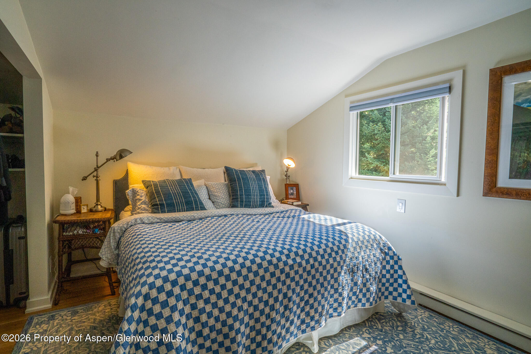 285 Conundrum Creek Road Aspen, CO 81611 - Photo 19 of 35 a bedroom with a bed and wooden floor