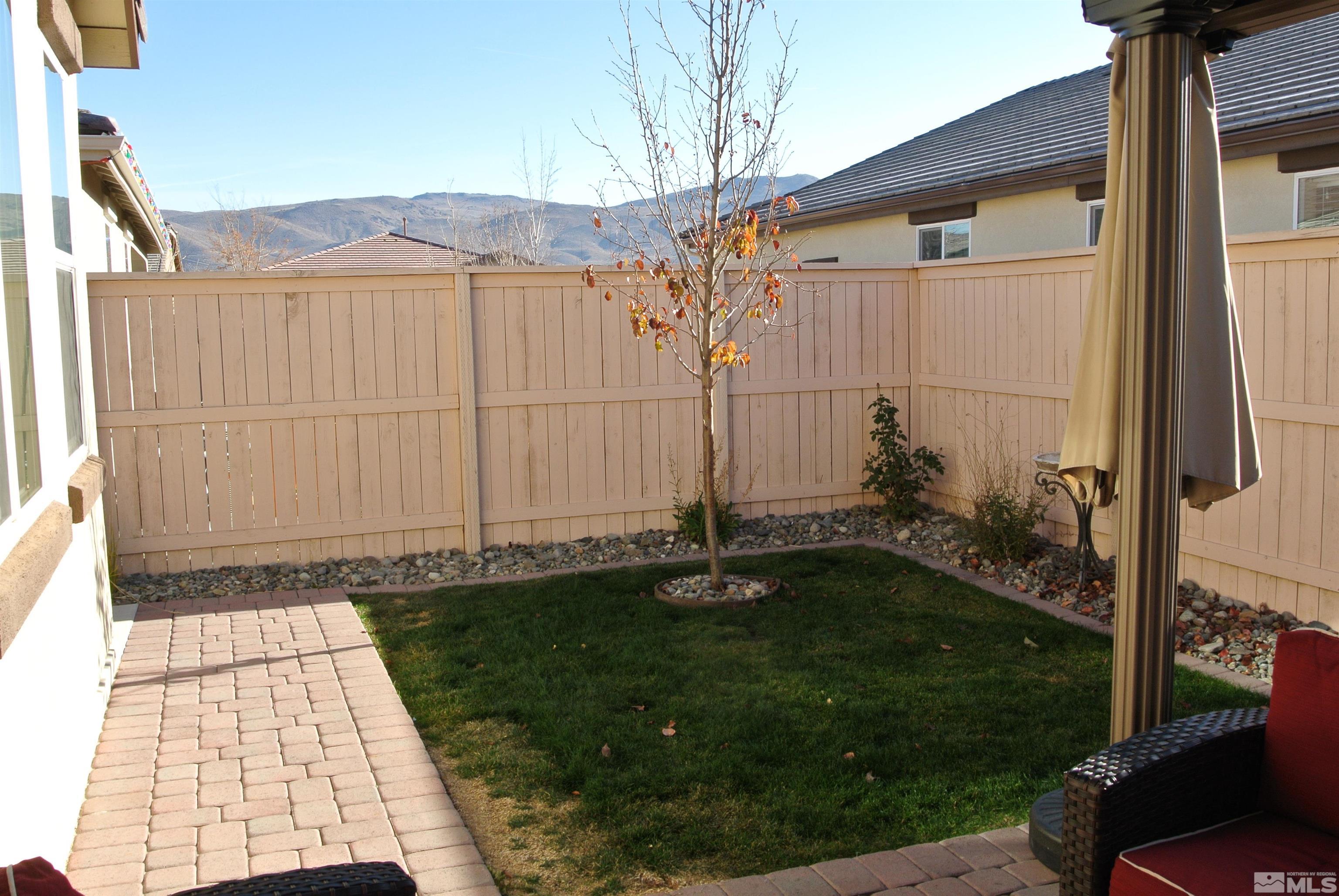 1888 Cholula Drive Reno, NV 89521 - Photo 17 of 17 a backyard of a house with lots of green space