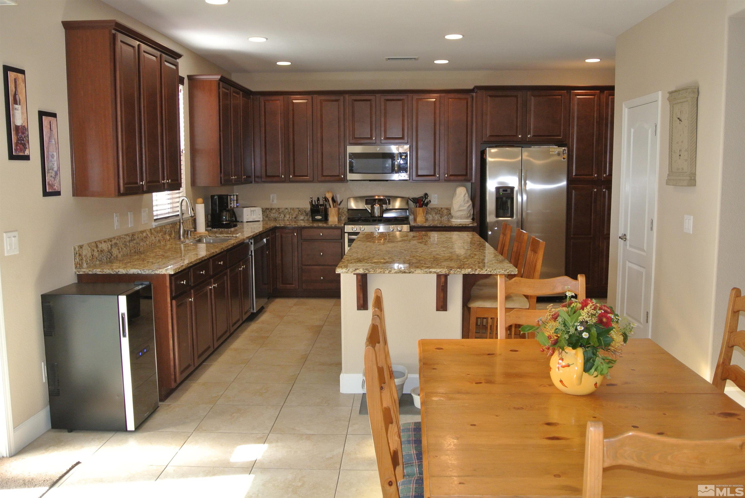 1888 Cholula Drive Reno, NV 89521 - Photo 4 of 17 a kitchen with stainless steel appliances granite countertop a sink stove and refrigerator