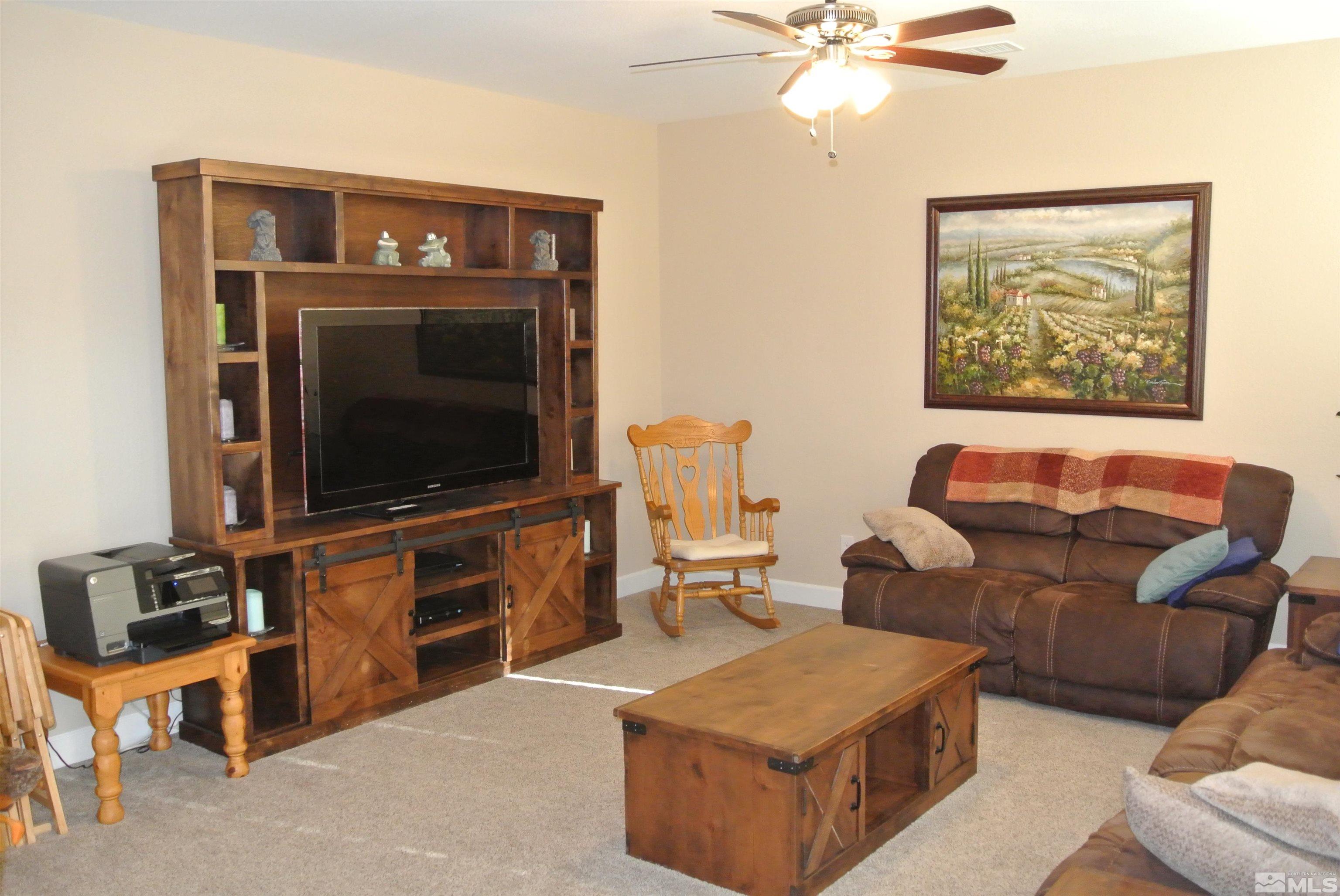 1888 Cholula Drive Reno, NV 89521 - Photo 5 of 17 a living room with furniture and a flat screen tv
