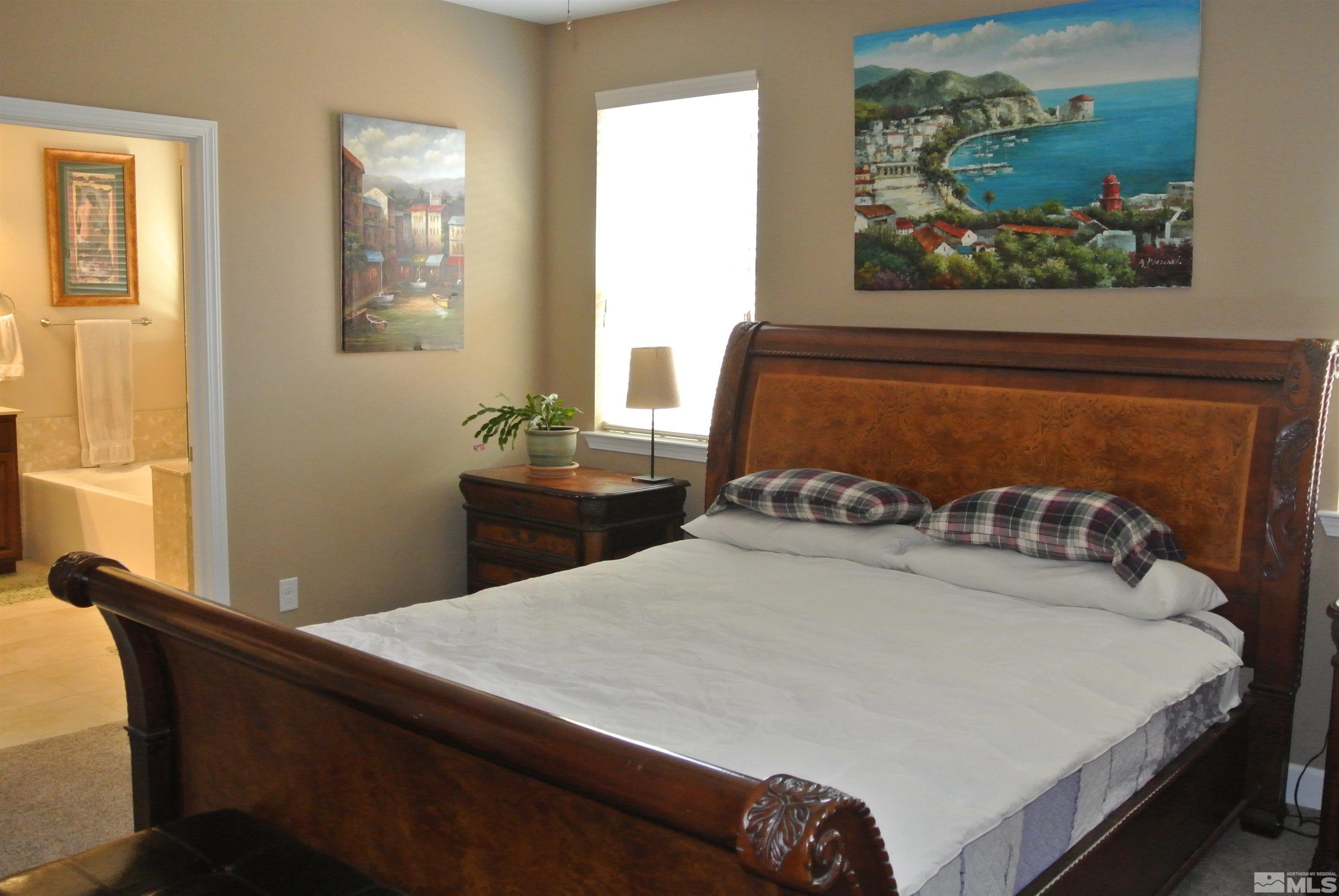 1888 Cholula Drive Reno, NV 89521 - Photo 7 of 17 a bedroom with a bed and a window