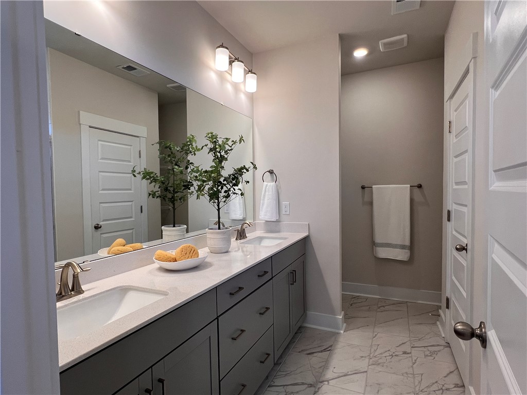 130 Tiger Lily Drive Anderson, SC 29621 - Photo 12 of 27 This spacious bathroom offers a double vanity and walk in shower.