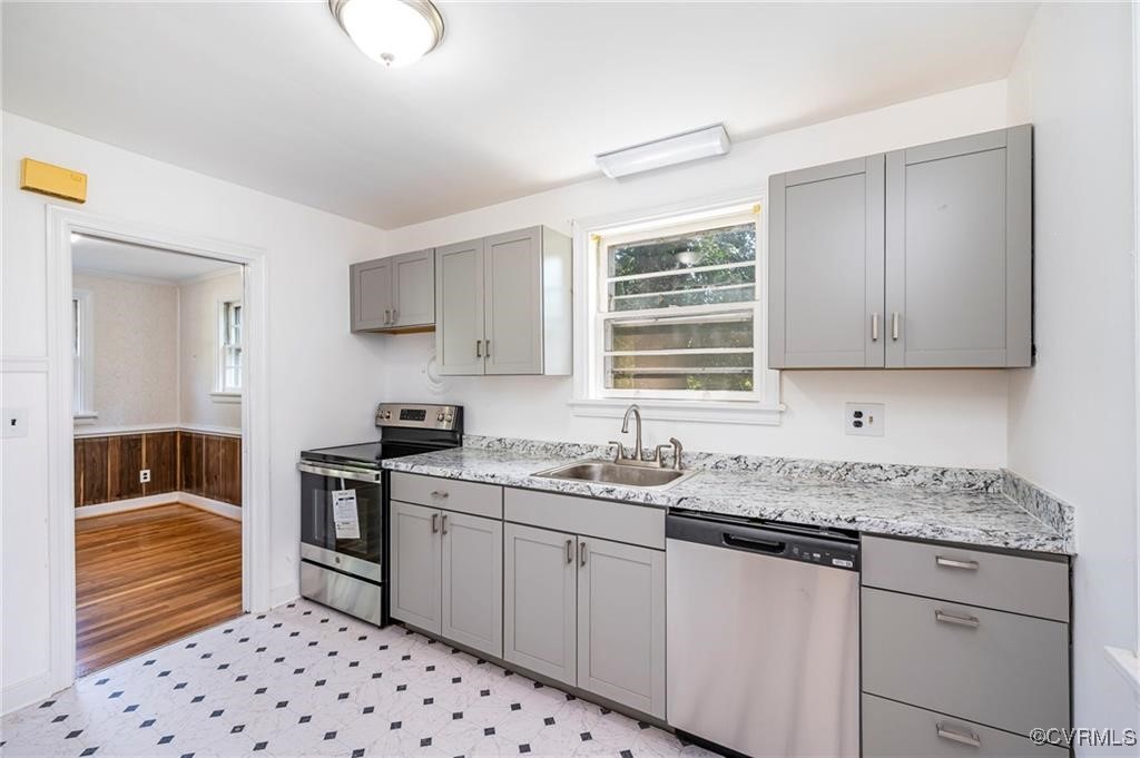 1215 Rosecroft Road Henrico, VA 23229 - Photo 16 of 22 a kitchen with granite countertop a sink stove and cabinets
