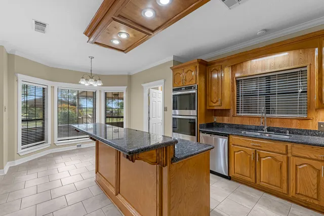 a kitchen with stainless steel appliances granite countertop a sink and counter space