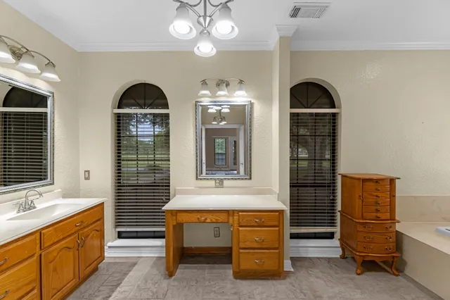 a view of hall way with furniture and chandelier