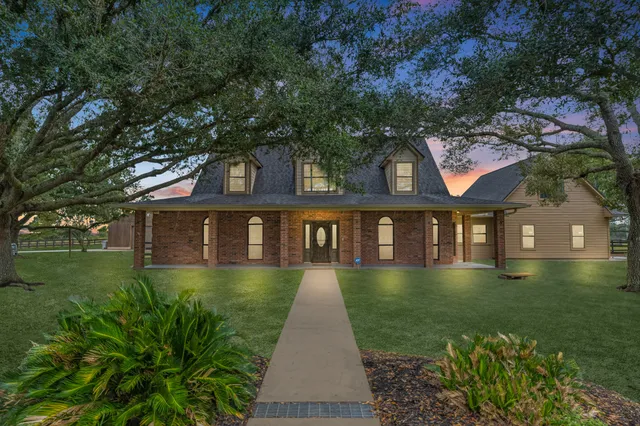a front view of a house with a garden