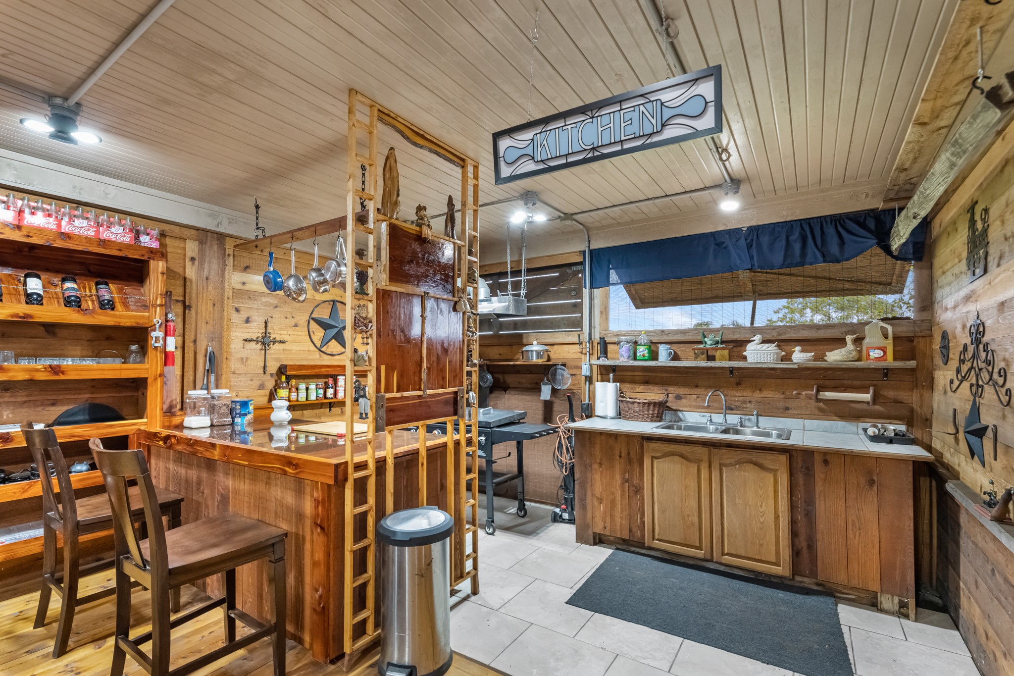 24849 County Road 48 Angleton, TX 77515 - Photo 39 of 48 a kitchen with stainless steel appliances kitchen island granite countertop a table chairs sink and cabinets