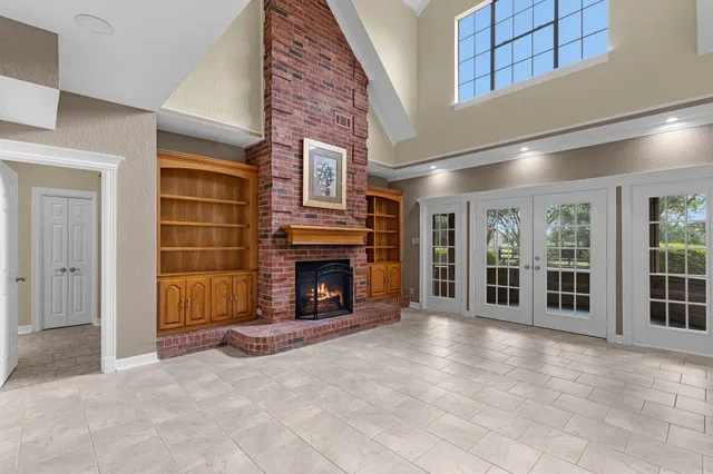 an empty room with fireplace and windows