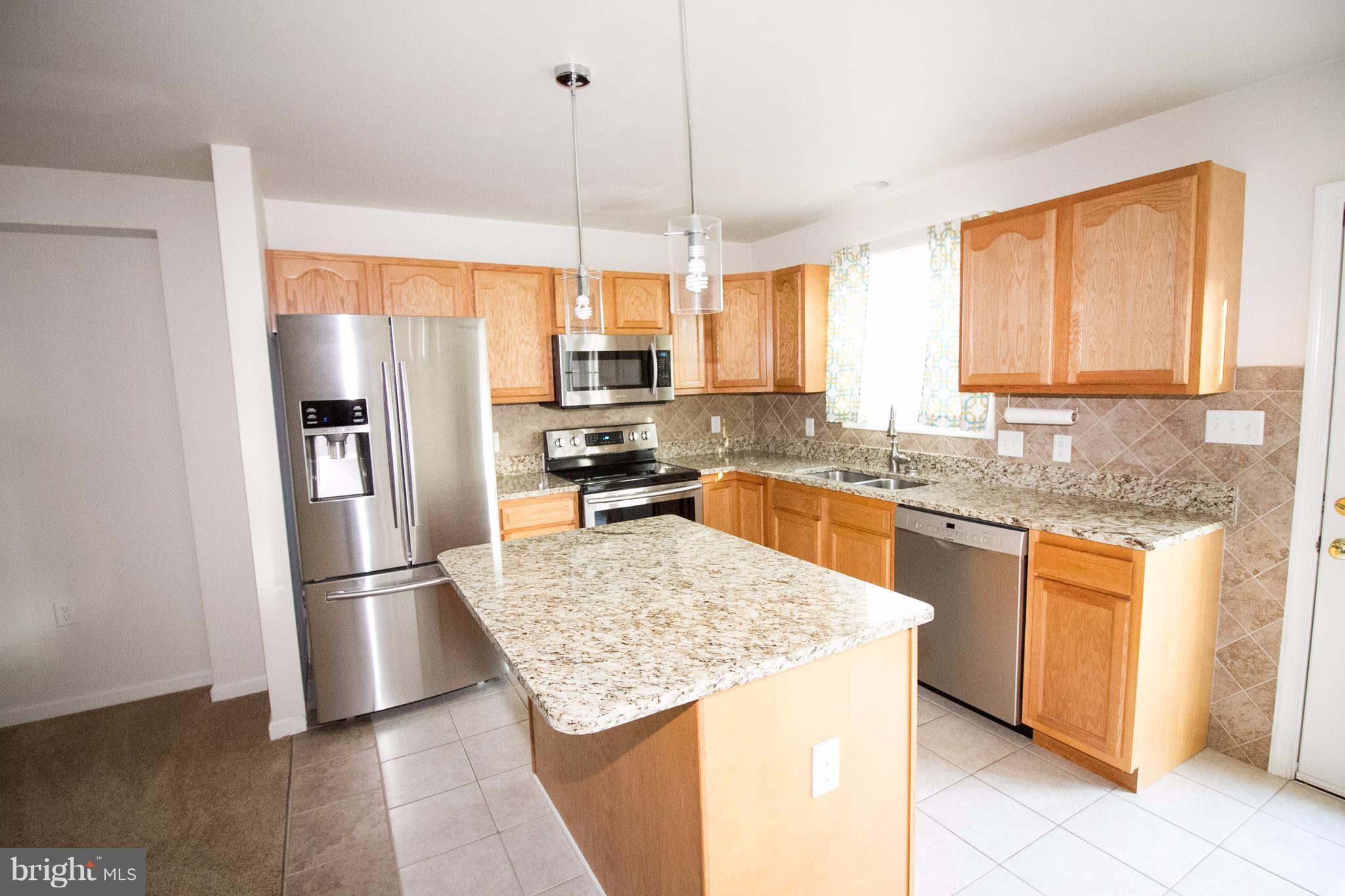 304 East 5th Avenue Ranson, WV 25438 - Photo 3 of 23 Kitchen boasts an island with space for stools