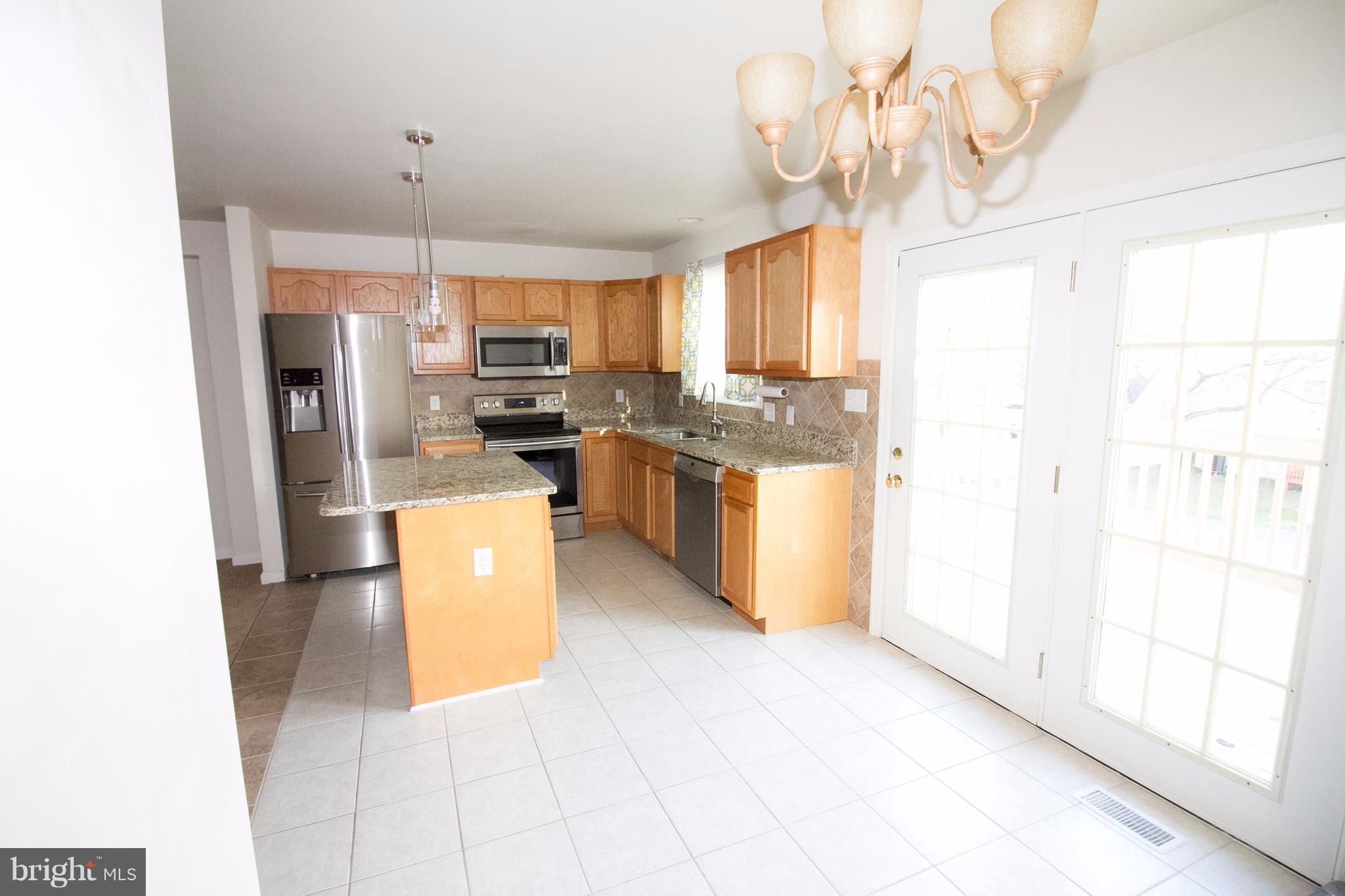 304 East 5th Avenue Ranson, WV 25438 - Photo 6 of 23 Dining area opens to the kitchen and leads to deck